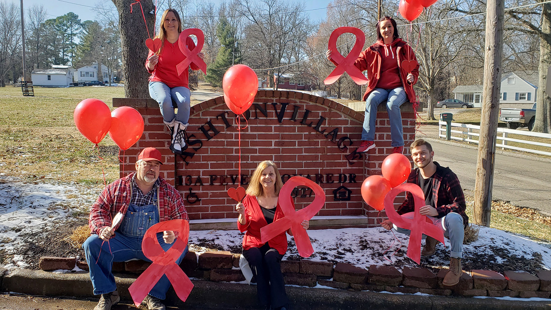 The Ashton Village team shows their support of National Heart Month with their red attire and décor.